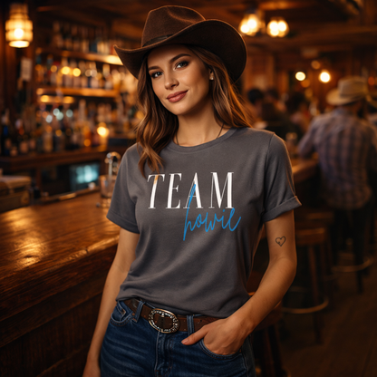 Woman wearing a gray 'TEAM howie' t-shirt in a bar setting