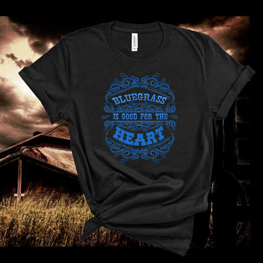 Black t-shirt with blue text 'Bluegrass is good for the heart' against a rustic background