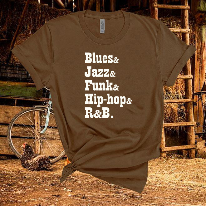 Brown t-shirt with text 'Blues & Jazz & Funk & Hip-hop & R&B' in a rustic setting with a chicken and bicycle.