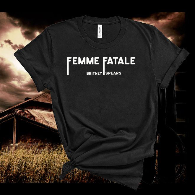 Black t-shirt with 'Femme Fatale' text against a dark, stormy sky background