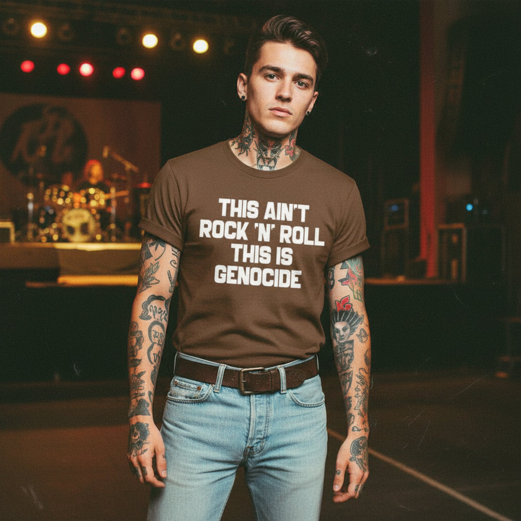 Brown t-shirt with text 'THIS AIN'T ROCK 'N' ROLL THIS IS GENOCIDE' in a rustic setting with a chicken and bicycle.