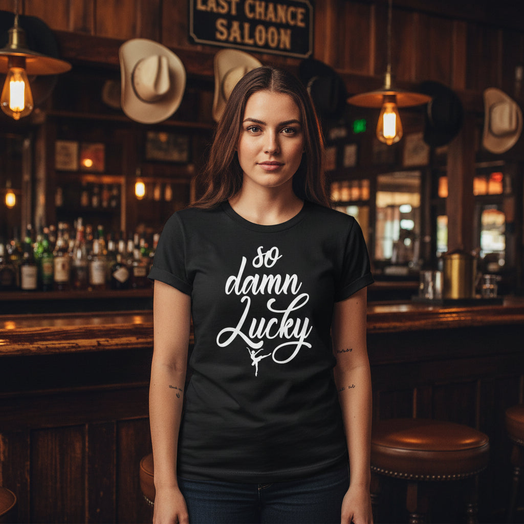 Black t-shirt with 'so damn lucky' text in white against a rustic background
