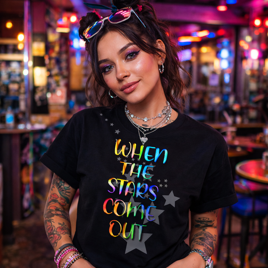 Person wearing a black t-shirt with colorful text in a neon-lit bar setting