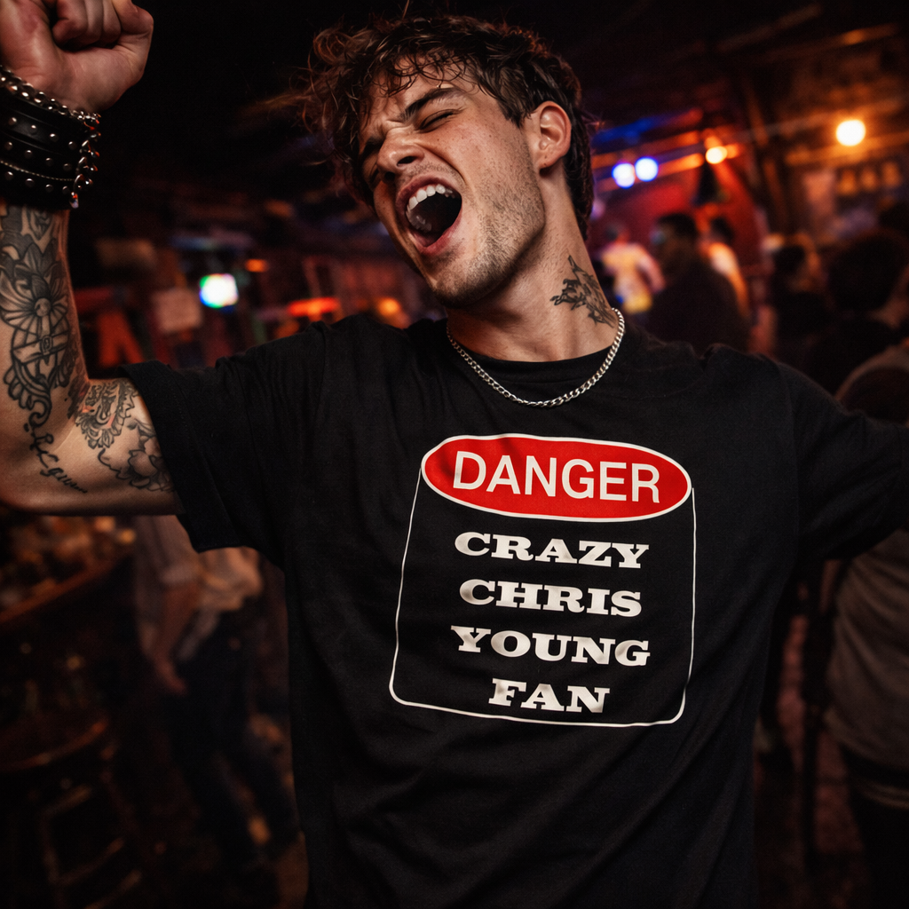 Person wearing a t-shirt with 'Danger Crazy Chris Young Fan' design in a lively setting.