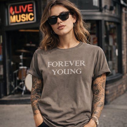 Woman wearing a 'Forever Young' t-shirt in front of a music venue.