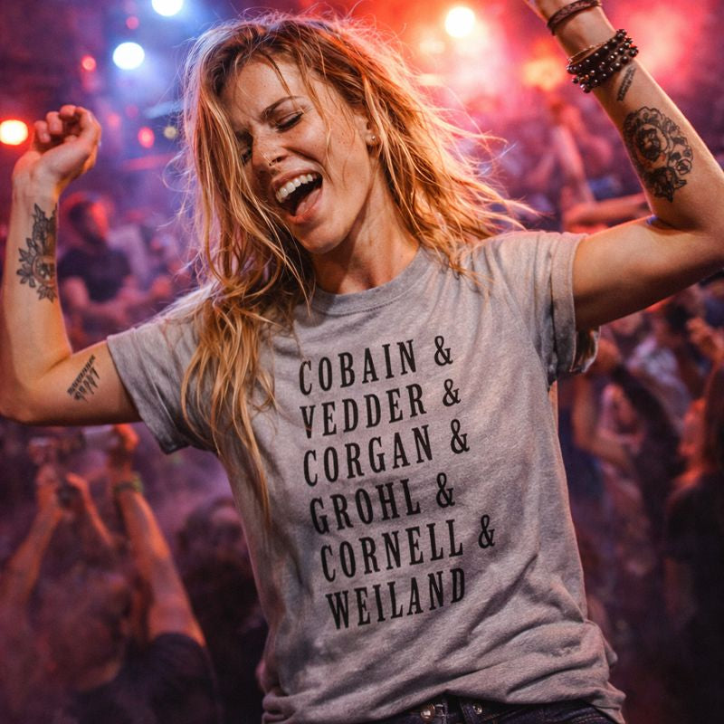 Person wearing a t-shirt with band names at a concert