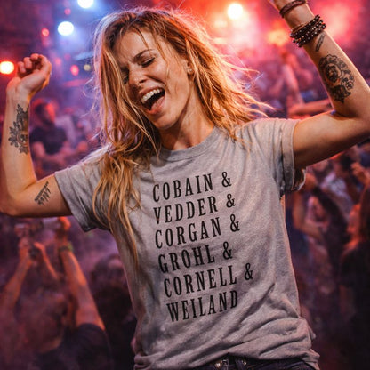 Person wearing a t-shirt with band names at a concert