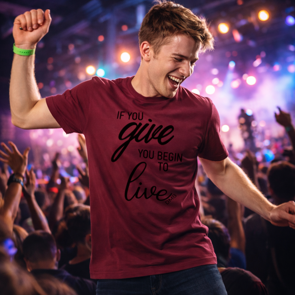 Man in a maroon t-shirt with motivational quote at a concert