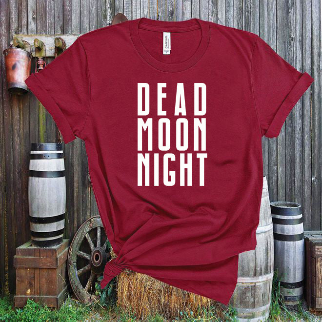 Red t-shirt with 'DEAD MOON NIGHT' text against a rustic wooden background