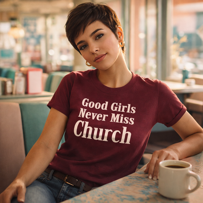 Woman wearing a t-shirt with 'Good Girls Never Miss Church' in a casual setting.