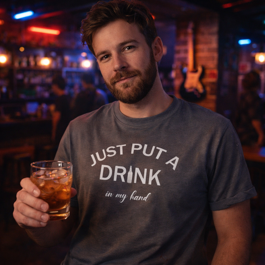 Man holding a drink in a bar wearing a t-shirt with text.