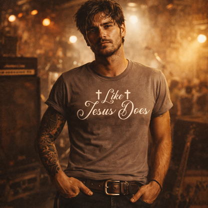Man wearing a t-shirt with 'Like Jesus Does' text in a warm-toned setting