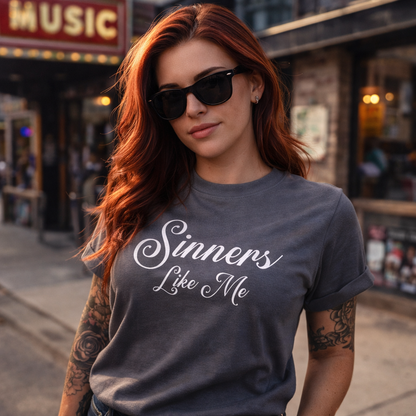 Woman wearing a 'Sinners Like Me' t-shirt in an urban setting
