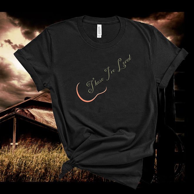 Black t-shirt with 'Those I've Loved' text and crescent moon graphic against a rustic background