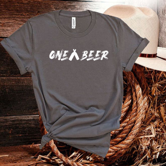 Gray t-shirt with 'ONE A BEER' text on a wooden surface with a straw hat.