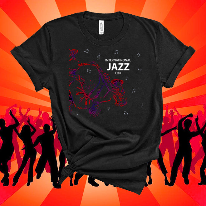 Black t-shirt with 'International Jazz Day' design on an orange background with silhouettes of people dancing.
