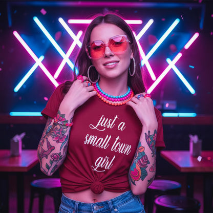 Red t-shirt with 'just a small town girl' text against a rustic wooden background.
