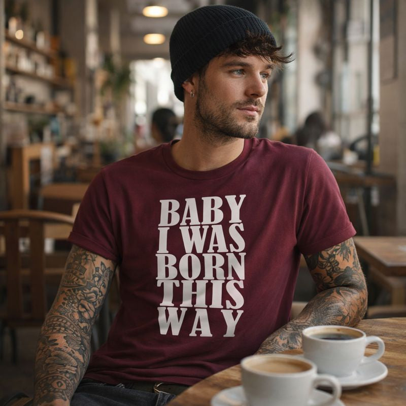 Man wearing a maroon t-shirt with text in a coffee shop