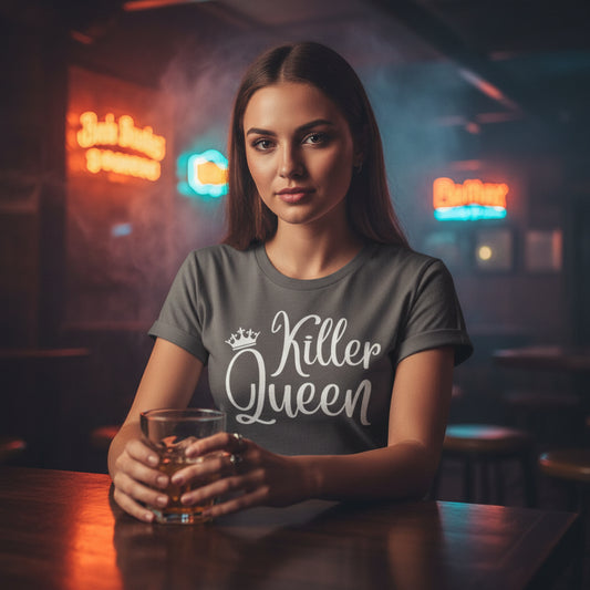Gray t-shirt with 'Killer Queen' text on a wooden surface with a hat and basket.