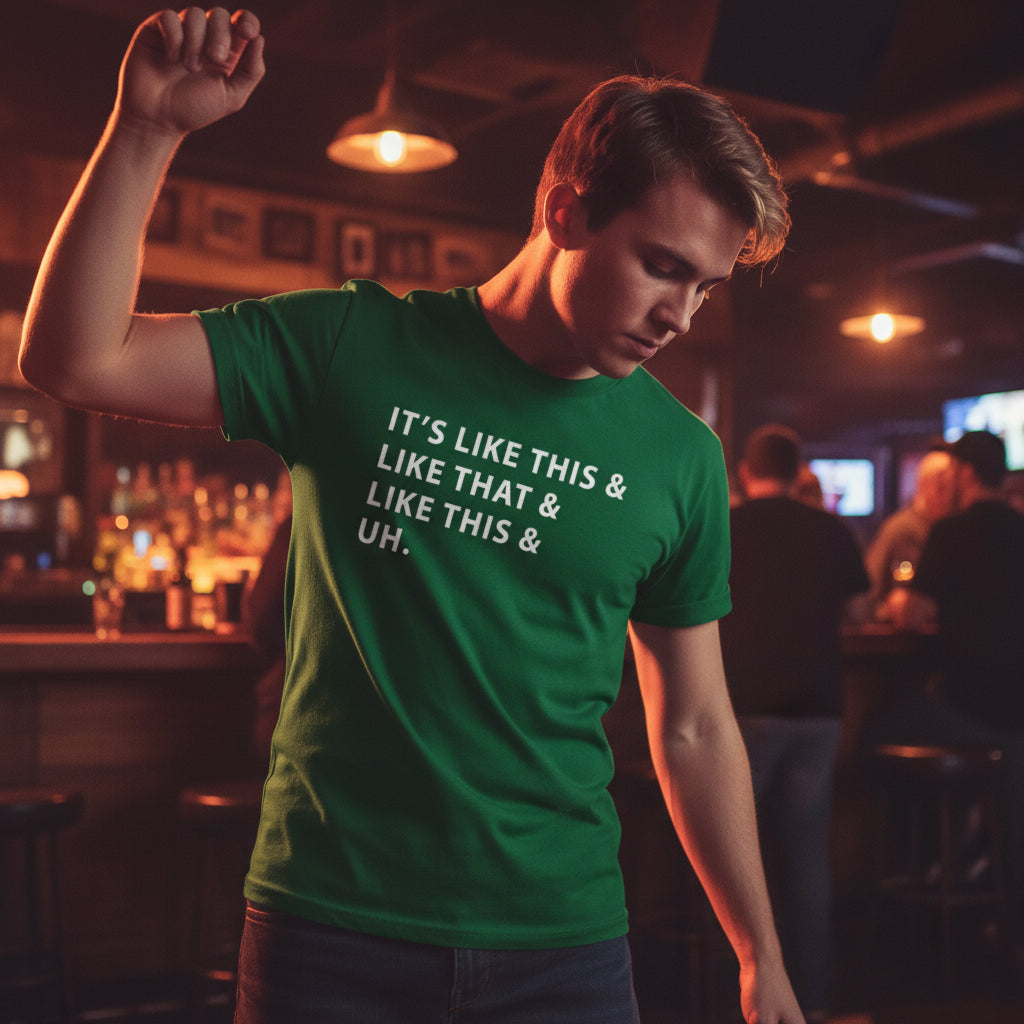 Green t-shirt with text on a wooden surface with cowboy boots and rope.