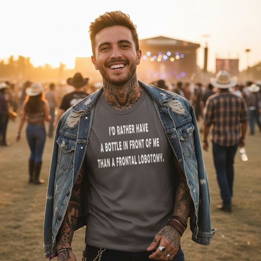 Gray t-shirt with humorous text on a wooden surface with a hat.