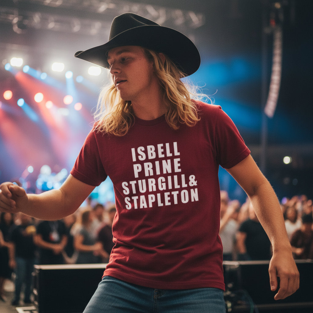 Red t-shirt with text 'ISBELL PRINE STURGILL & STAPLETON' against a rustic wooden background.