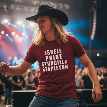 Red t-shirt with text 'ISBELL PRINE STURGILL & STAPLETON' against a rustic wooden background.